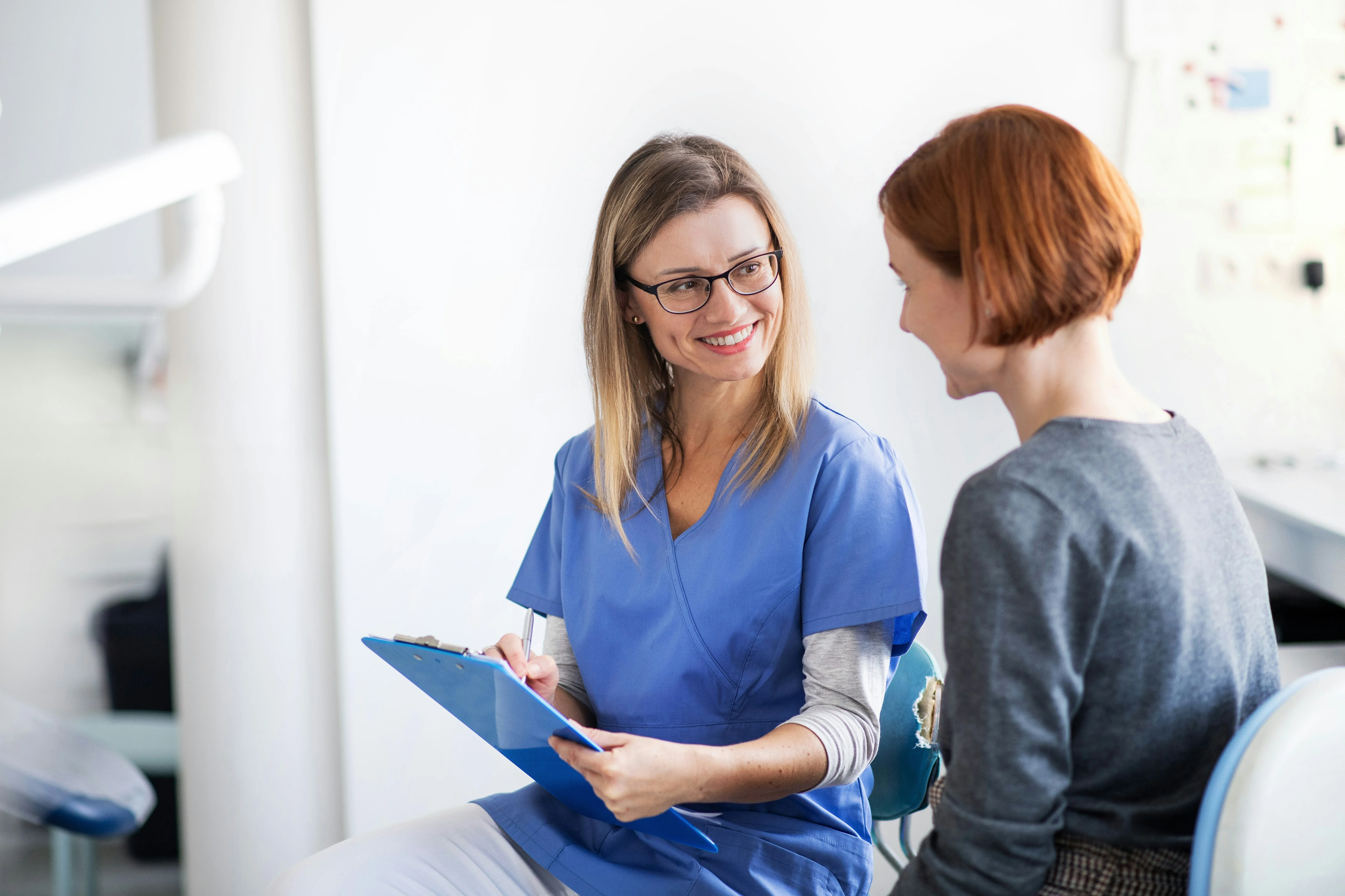 Clinician reviewing a patient follow-up on her phone